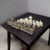 Camel bone chess pieces of elephant theme, white and antique finesh on a black color table