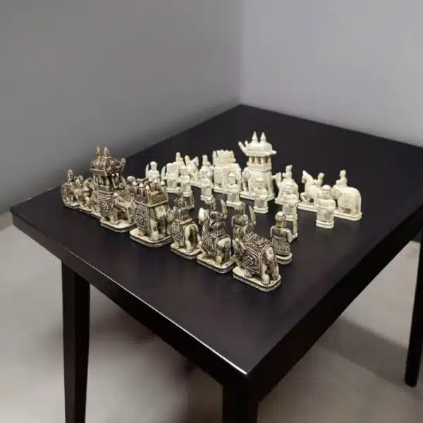 Camel bone chess pieces of elephant theme, white and antique finesh on a black color table