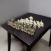Camel bone chess pieces of elephant theme, white and antique finesh on a black color table