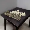 Camel bone chess pieces of elephant theme, white and antique finesh on a black color table