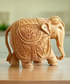 Handcrafted wooden elephant sculpture with intricate carvings, showcasing traditional artistry.