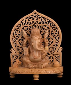 Wooden Ganesha statue with ornate carved arch and devotional details.