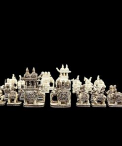 Intricate handcrafted camel bone chess set featuring cultural warriors, elephants, and palace structures