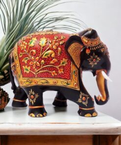 Colorful Indian elephant figurine with gold accents, floral motifs, and raised trunk for good luck.