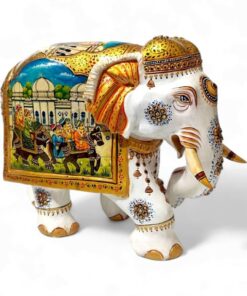 Decorative elephant sculpture with intricate designs and scenic painted saddle.