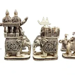 Intricate ivory elephant figurines with regal palanquin and traditional carvings