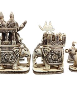 Intricate ivory elephant figurines with regal palanquin and traditional carvings