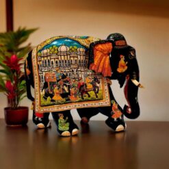 Colorful decorative Indian elephant sculpture with intricate patterns, regal scene, and vibrant traditional details.