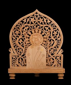 Wooden Ganesha statue backdrop with ornate carved floral arch and shrine panel.
