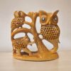 Wooden sculpture of owls, elephant, and tree emphasizing wildlife art and nature-inspired decor.