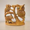 Wooden sculpture of owls, elephant, and tree emphasizing wildlife art and nature-inspired decor.