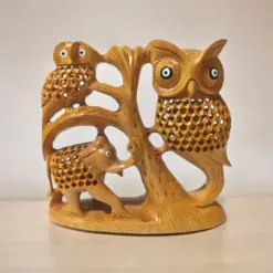 Wooden sculpture of owls, elephant, and tree emphasizing wildlife art and nature-inspired decor.