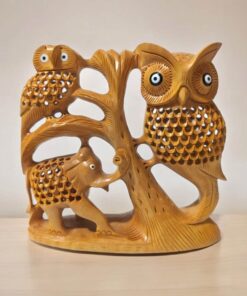 Wooden sculpture of owls, elephant, and tree emphasizing wildlife art and nature-inspired decor.