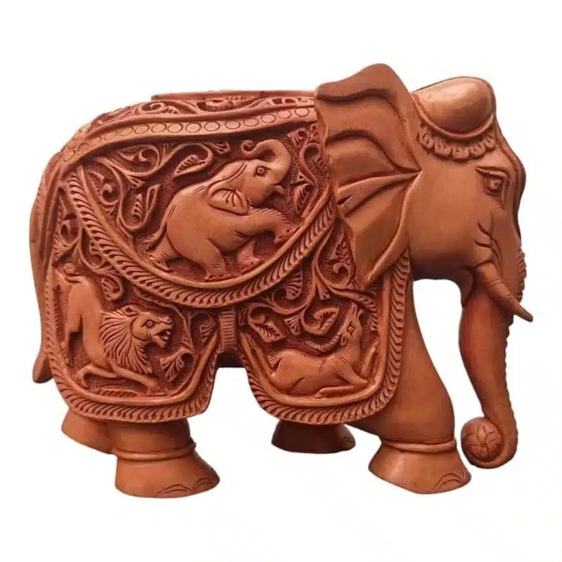 Handmade elephant sculpture with flower carving and animal figure on its body