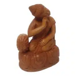Wooden Buddha statue sitting on in resting pose right hand on cushion