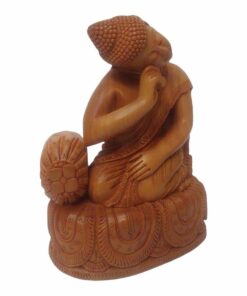 Wooden Buddha statue sitting on in resting pose right hand on cushion