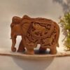 Hand-carved clay elephant sculpture with intricate patterns and wildlife motifs, showcasing traditional craftsmanship.