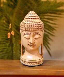 Wooden Buddha face placed on a wood table