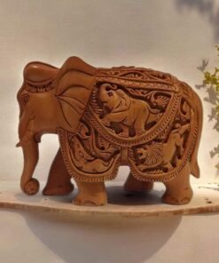 Hand-carved clay elephant sculpture with intricate patterns and wildlife motifs, showcasing traditional craftsmanship.