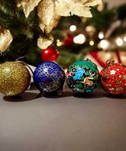 Paper Mache balls painted on table in front Christmas tree