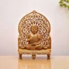 Wooden Buddha statue sitting on carved wood stand in meditation pose