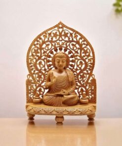 Wooden Buddha statue sitting on carved wood stand in meditation pose