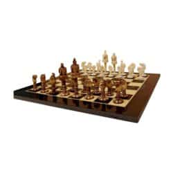 bone chess set on checkered board with detailed white and dark brown pieces.