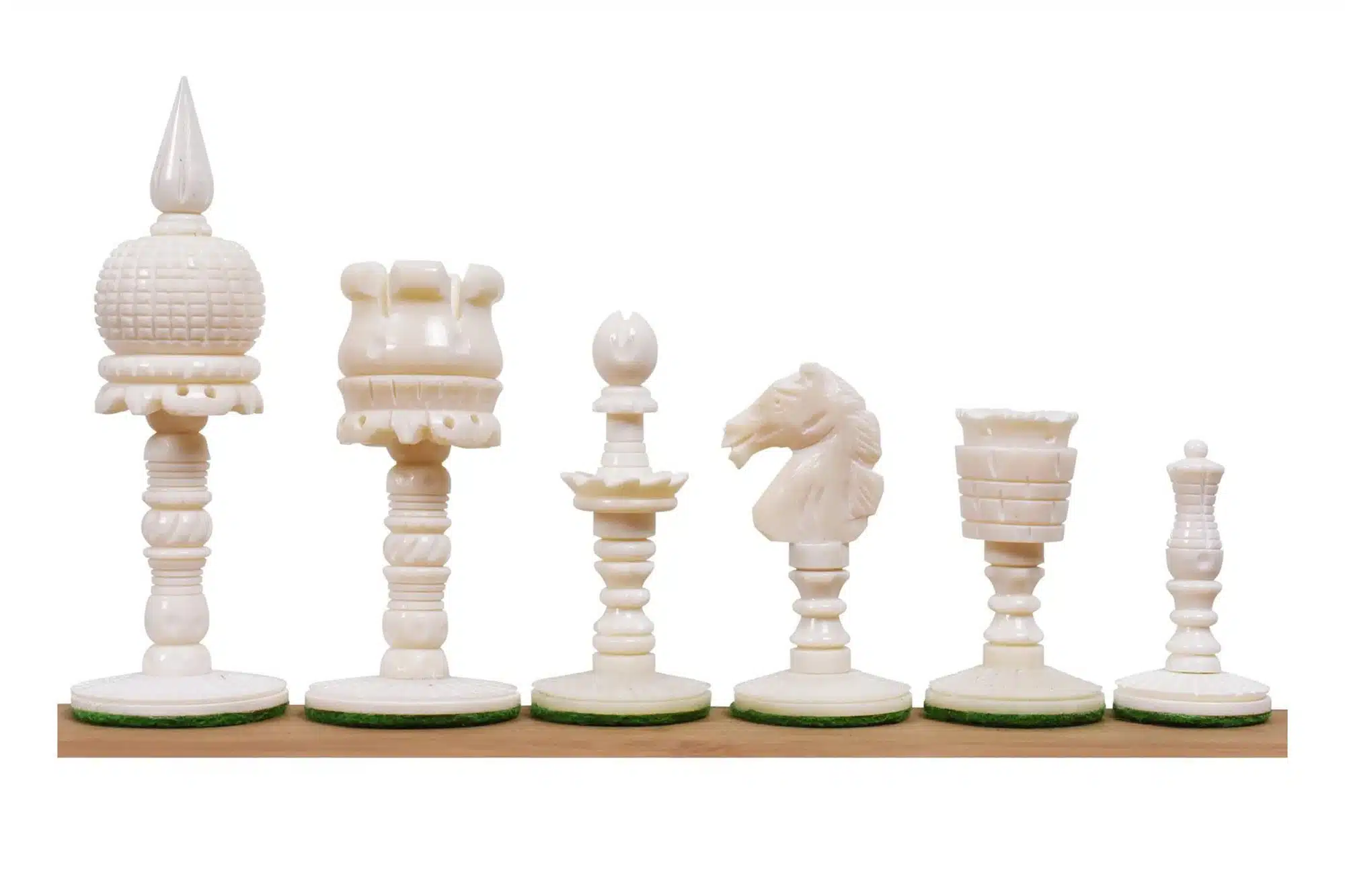Elegant bone chess set with detailed carved pieces on green felt bases.