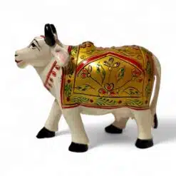 Ceramic cow figurine with colorful painted blanket, traditional craftsmanship, symbolizing prosperity and cultural heritage.