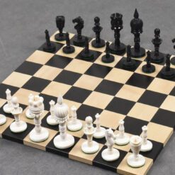 Elegant carved black and white chess set on a classic board for strategic gameplay.