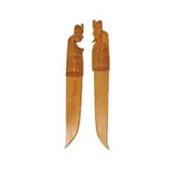 Hand-carved wooden kitchen utensils featuring detailed cultural figures and symbolic motifs.