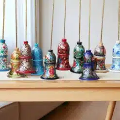 Decorative Paper Mache Bells On Wooden Table