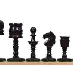 Elegant black chess pieces set with intricate carvings on a wooden chessboard.