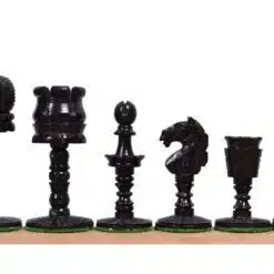 Elegant black chess pieces set with intricate carvings on a wooden chessboard.