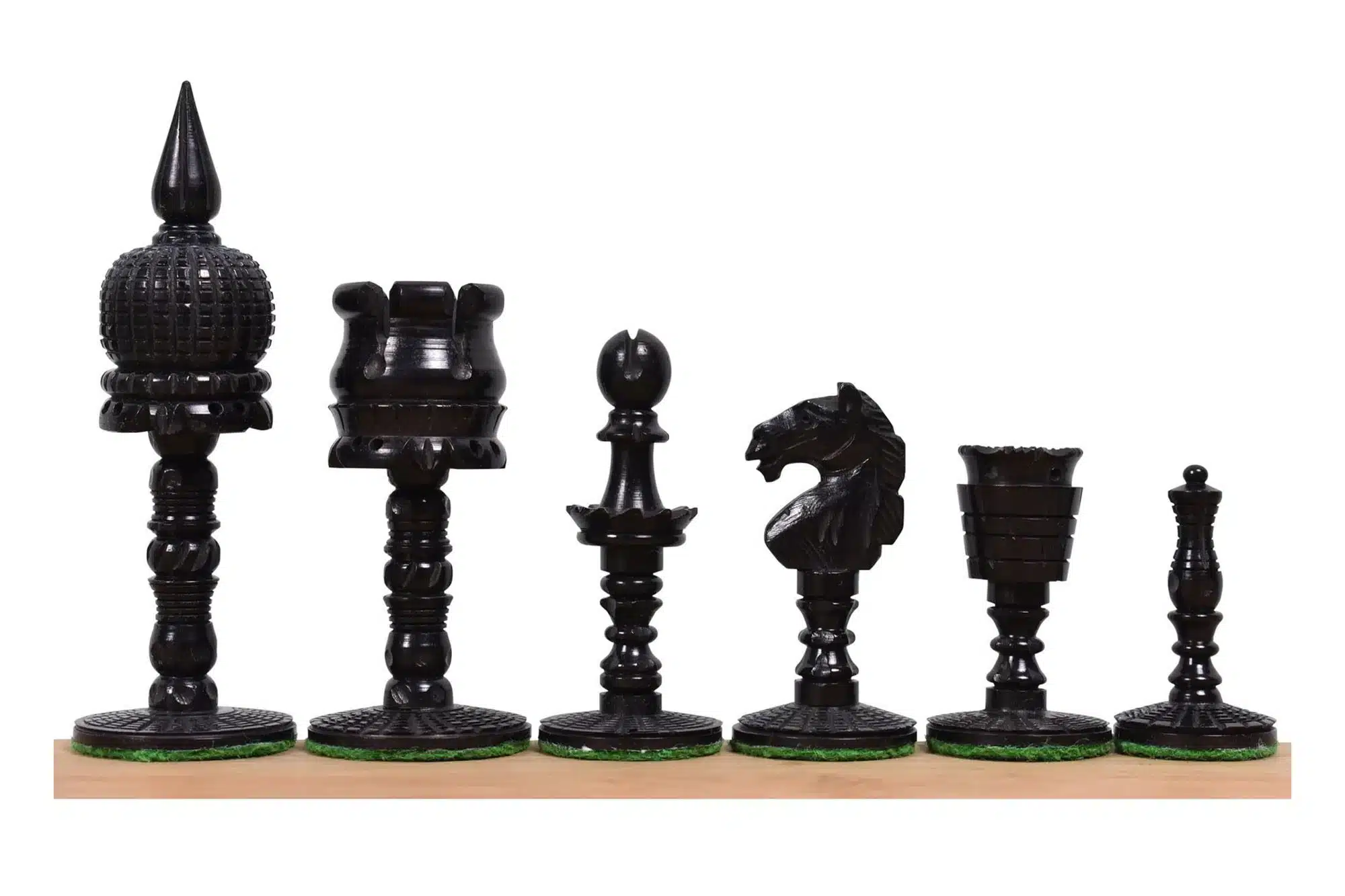 Elegant black chess pieces set with intricate carvings on a wooden chessboard.