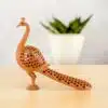 Peacock sculpture with intricate cutouts and graceful design for home decor and art.