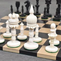 Beautiful handcrafted white and black chess set on a classic chessboard for strategy and craftsmanship.