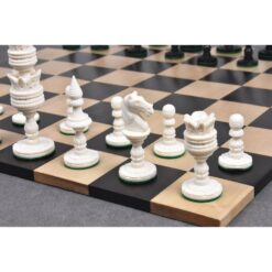 Elegant carved white chess pieces on classic wooden chessboard with black and honey-colored squares.
