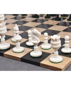 Elegant carved white chess pieces on classic wooden chessboard with black and honey-colored squares.