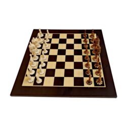 Elegant chessboard with intricately crafted ivory and dark brown chess pieces, showcasing artistic craftsmanship and design.