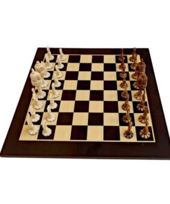 Elegant chessboard with intricately crafted ivory and dark brown chess pieces, showcasing artistic craftsmanship and design.