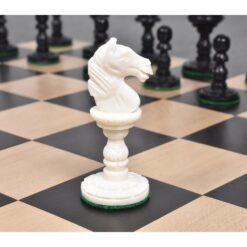 White knight chess piece on wooden and black checkered board with opposing black chess pieces.