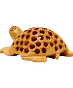 Decorative handcrafted clay turtle figurine with carved perforated shell and natural earthy tones.
