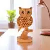 Hand-carved wooden owl figurine with intricate details and expressive eyes for home decor.
