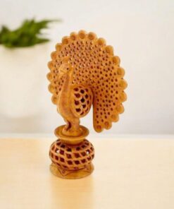 Hand-carved wooden peacock sculpture with intricate fan-shaped tail and decorative base.