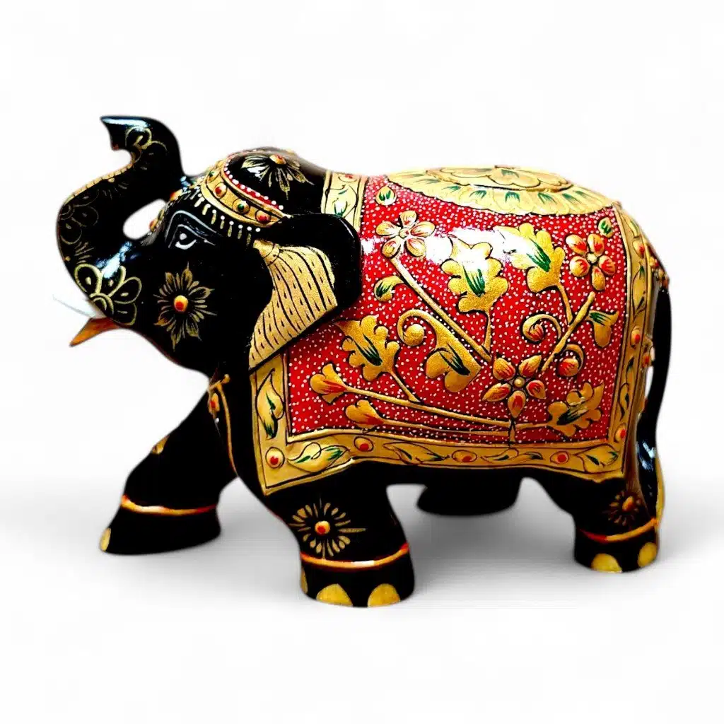 Glossy black Indian elephant figurine with red gold floral painted saddle.