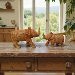 hand-carved wooden rhino statue on a table