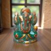 a hand-painted green jade Ganesha statue featuring gold accents