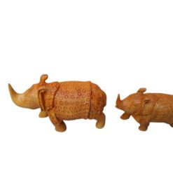 Handcrafted brown rhinoceros figurine pair with carved tribal patterns.