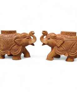 Handcrafted wood elephant planter pair with raised trunks and carved floral patterns.